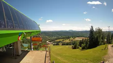Widok na stok narciarski i kolej z górnej stacji kompleksu Słotwiny Arena w Krynicy