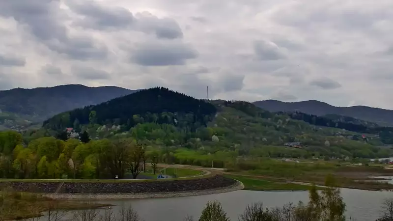 Widok z kamery ukazuje malowniczą linię brzegową, nad którą góruje charakterystyczna zapora w Świnnej Porębie